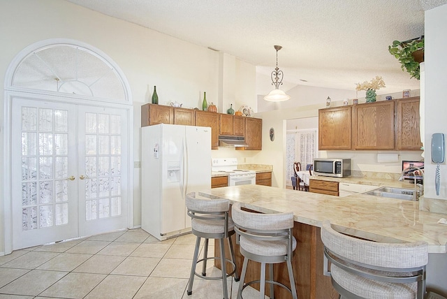 kitchen with french doors, white appliances, a peninsula, and a sink