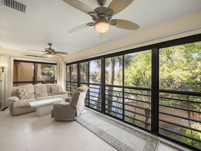 sunroom featuring visible vents and ceiling fan