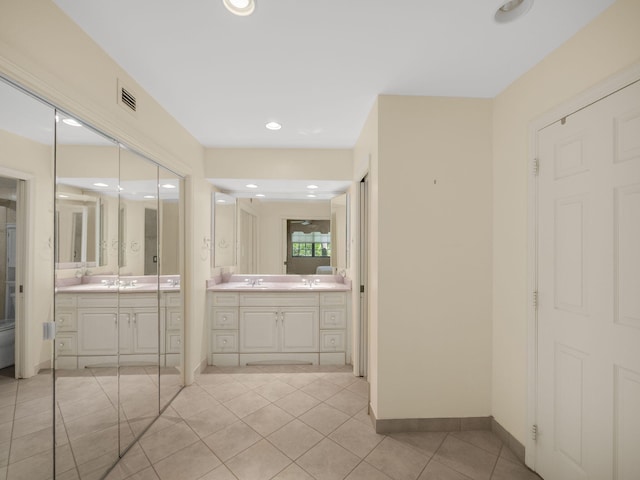 bathroom featuring a sink, two vanities, tile patterned flooring, and visible vents