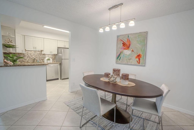9785 Pineapple Tree Dr Unit 103, Boynton Beach, FL 33436 - dining room with light tile patterned flooring and a textured ceiling