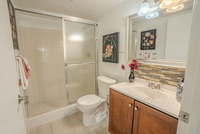 9785 Pineapple Tree Dr Unit 103, Boynton Beach, FL 33436 - full bathroom with vanity, a stall shower, decorative backsplash, and wood finished floors