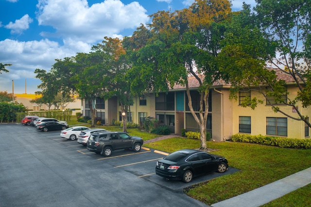 view of property featuring uncovered parking