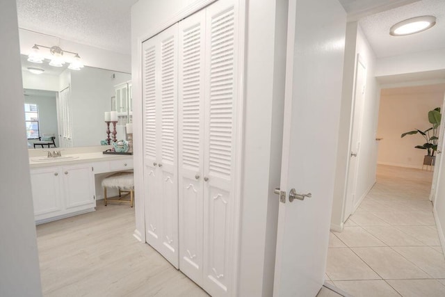 9785 Pineapple Tree Dr Unit 103, Boynton Beach, FL 33436 - corridor with a desk, a textured ceiling, and light tile patterned floors