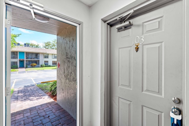 9785 Pineapple Tree Dr Unit 103, Boynton Beach, FL 33436 - doorway to outside featuring brick flooring