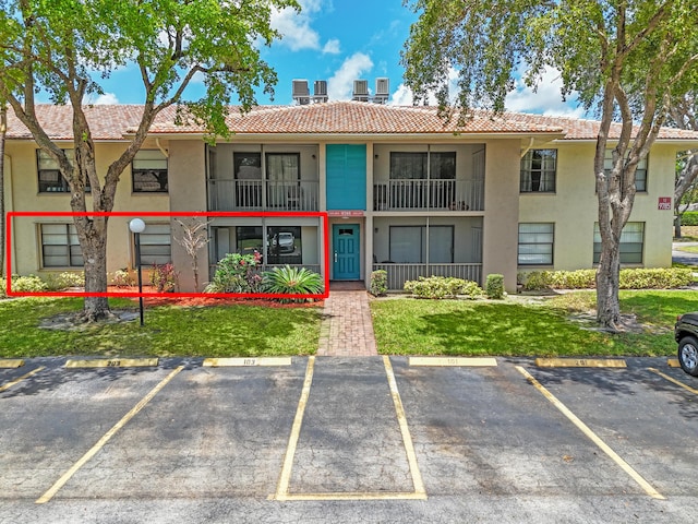 9785 Pineapple Tree Dr Unit 103, Boynton Beach, FL 33436 - view of building exterior with uncovered parking