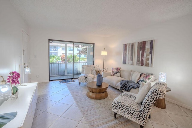 9785 Pineapple Tree Dr Unit 103, Boynton Beach, FL 33436 - living room with tile patterned floors and a textured ceiling