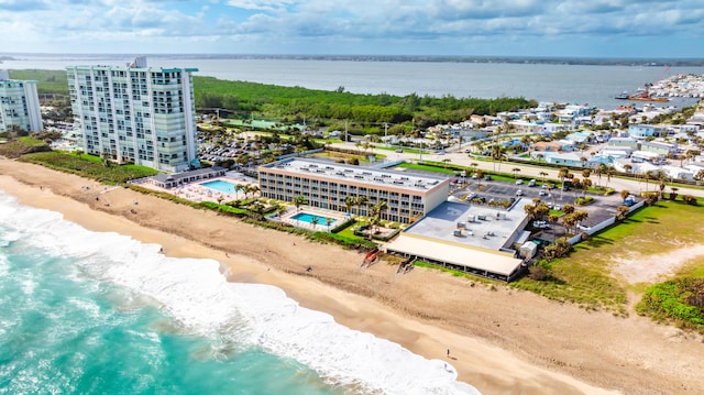 drone / aerial view with a water view and a beach view