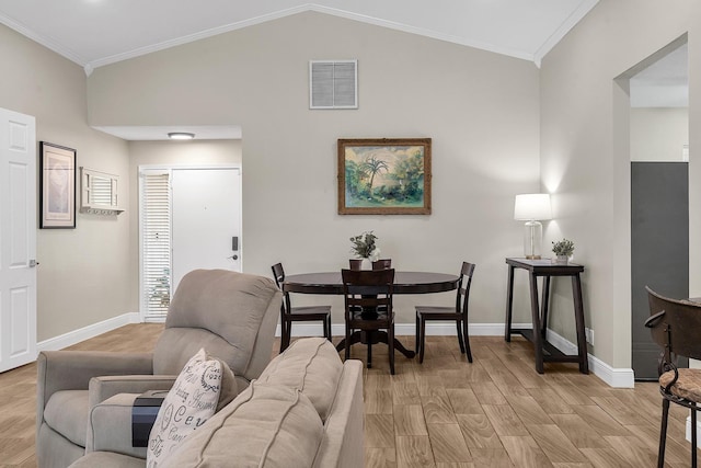 dining space with light wood finished floors, baseboards, visible vents, and ornamental molding