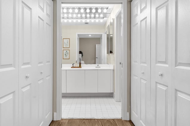 bathroom with a closet and vanity