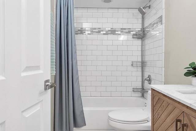 bathroom featuring shower / tub combo, vanity, and toilet