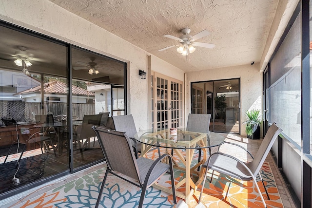 sunroom featuring a ceiling fan