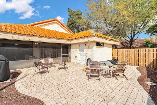 view of patio featuring a sunroom, fence, and area for grilling