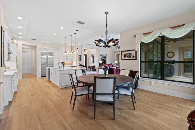 dining space with recessed lighting, a notable chandelier, visible vents, baseboards, and light wood finished floors