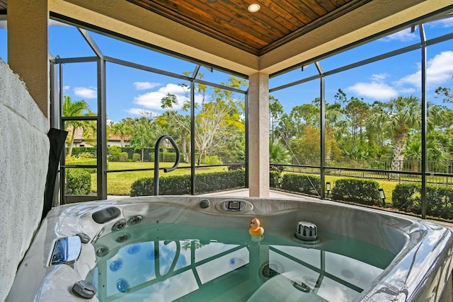 unfurnished sunroom featuring wood ceiling and a jacuzzi