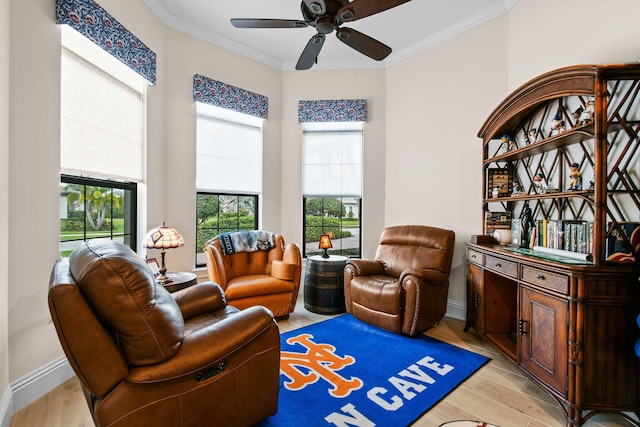 living area featuring ornamental molding, baseboards, and light wood finished floors