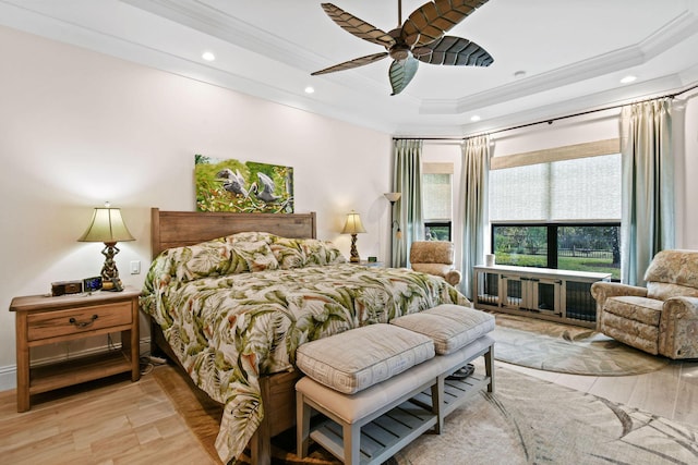 bedroom featuring recessed lighting, a raised ceiling, crown molding, and wood finished floors