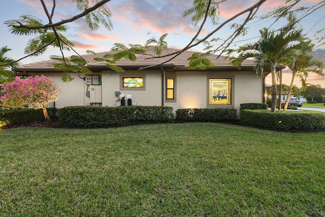 exterior space featuring a yard and stucco siding