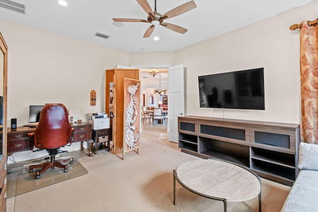 carpeted home office featuring recessed lighting, visible vents, and ceiling fan with notable chandelier