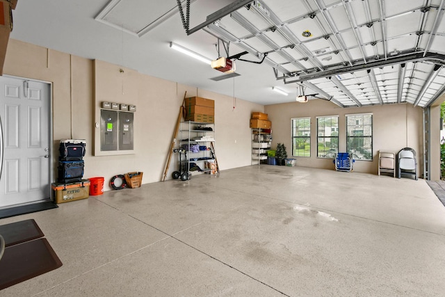 garage with electric panel and a garage door opener