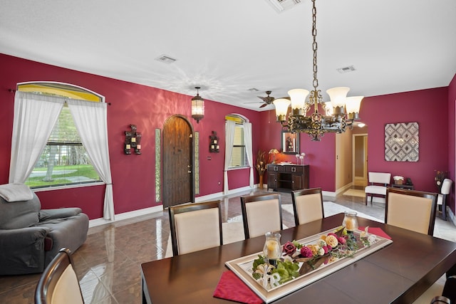 dining area featuring baseboards, visible vents, and arched walkways