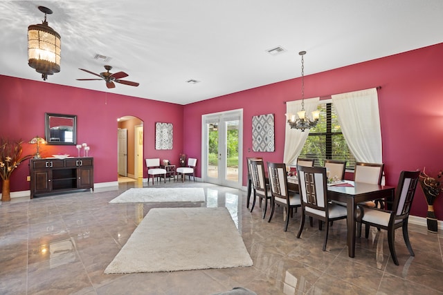 dining space with arched walkways, french doors, visible vents, and baseboards