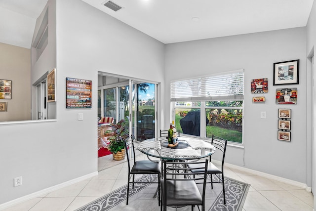 dining area with light tile patterned flooring, visible vents, and baseboards