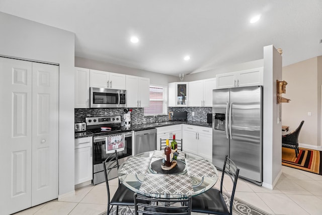 kitchen featuring light tile patterned floors, stainless steel appliances, and backsplash