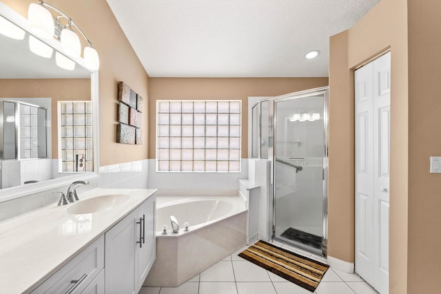 bathroom featuring a stall shower, a garden tub, and tile patterned floors