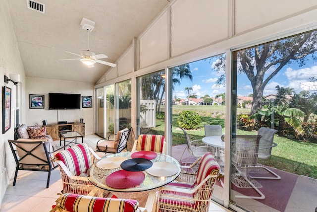 sunroom featuring vaulted ceiling, visible vents, and a ceiling fan