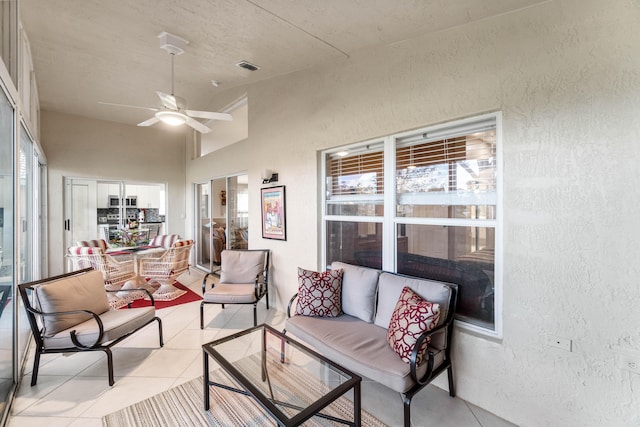 sunroom / solarium with plenty of natural light, visible vents, vaulted ceiling, and a ceiling fan