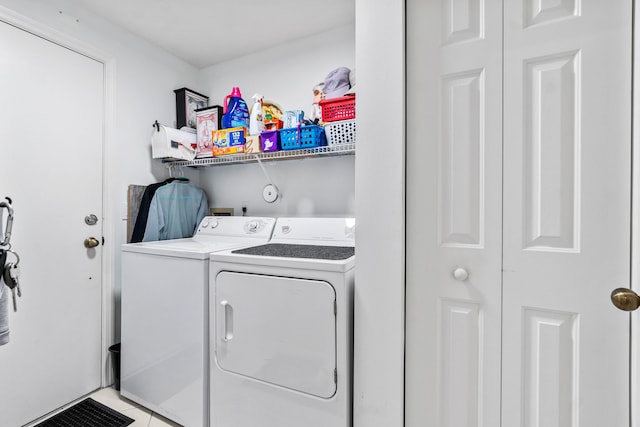 laundry room featuring laundry area, washing machine and dryer, and light tile patterned floors