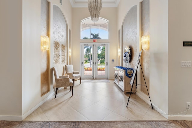 doorway featuring tile patterned flooring, a high ceiling, baseboards, french doors, and crown molding