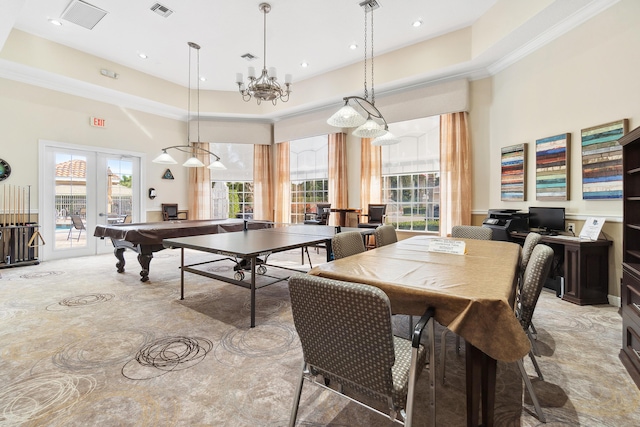 game room with a tray ceiling, french doors, a towering ceiling, and visible vents