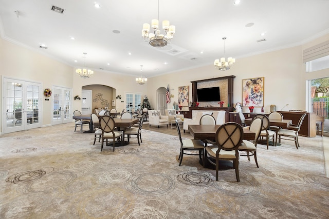 dining room featuring a wealth of natural light, visible vents, and a notable chandelier