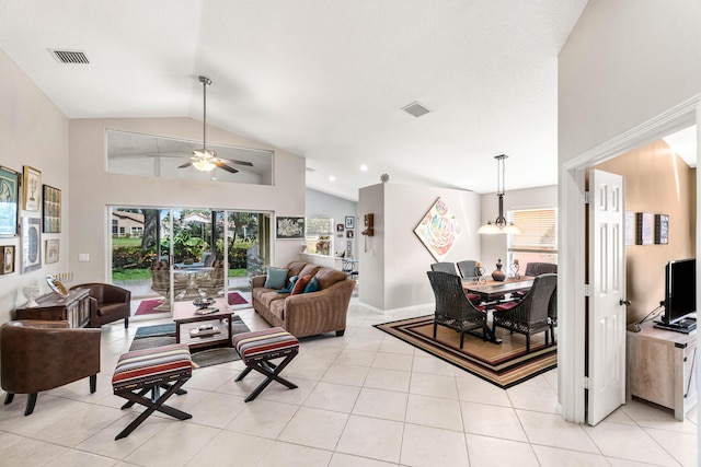 living area featuring light tile patterned floors, visible vents, and a healthy amount of sunlight