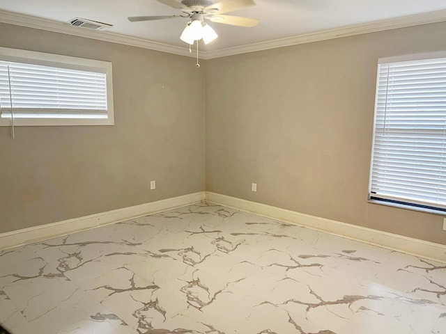 spare room featuring marble finish floor, visible vents, crown molding, and baseboards