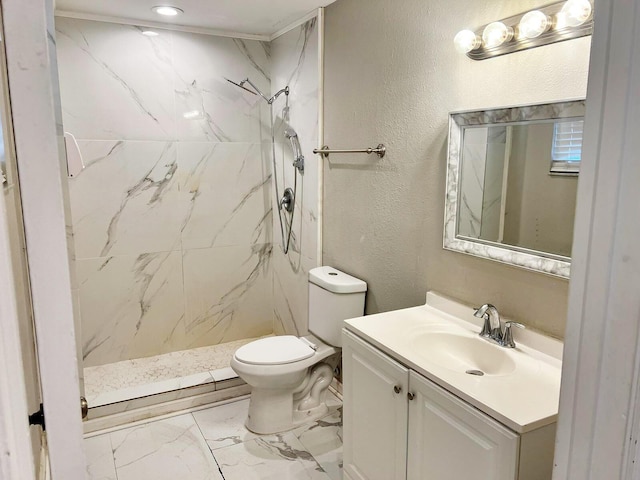 bathroom featuring marble finish floor, a marble finish shower, a textured wall, toilet, and vanity