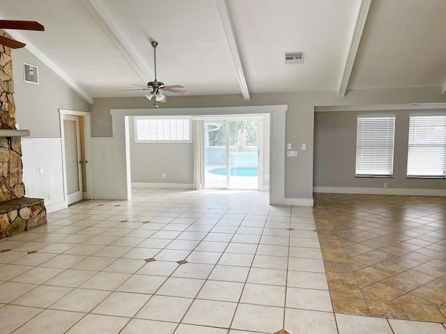 unfurnished living room with a ceiling fan, visible vents, lofted ceiling with beams, and light tile patterned floors