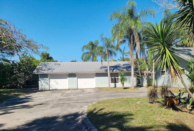 view of front of home featuring concrete driveway and an attached garage