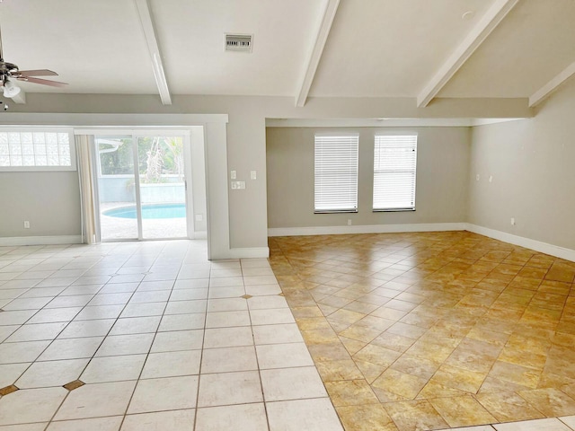 spare room featuring visible vents, beamed ceiling, and baseboards