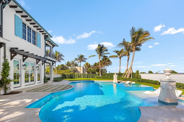 view of pool with a patio area, a fenced in pool, a pergola, and french doors