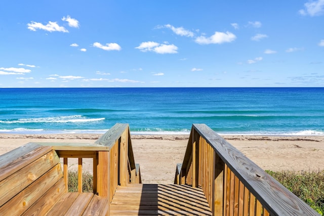 view of community with a beach view and a water view