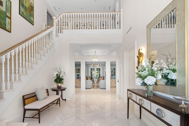 foyer featuring a towering ceiling and stairs