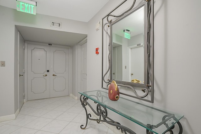 bathroom with tile patterned flooring, visible vents, and baseboards