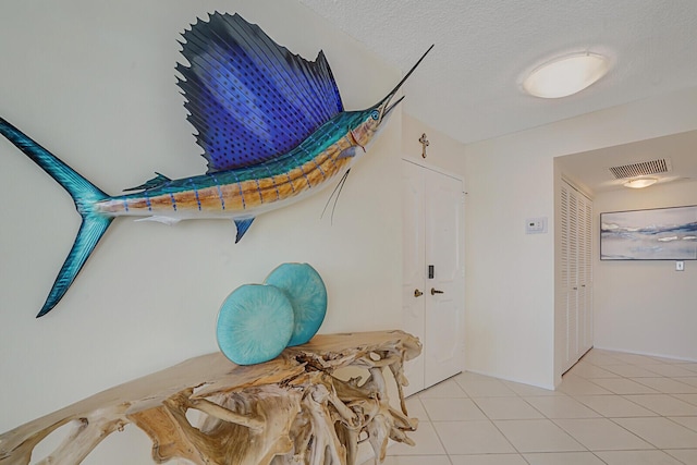 room details featuring visible vents and a textured ceiling