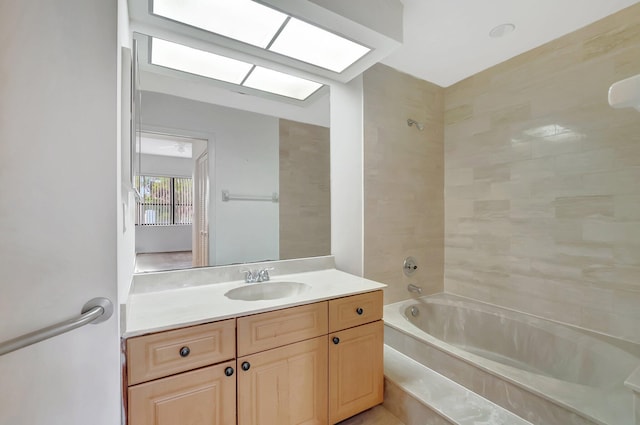 bathroom featuring a skylight, shower / tub combination, and vanity