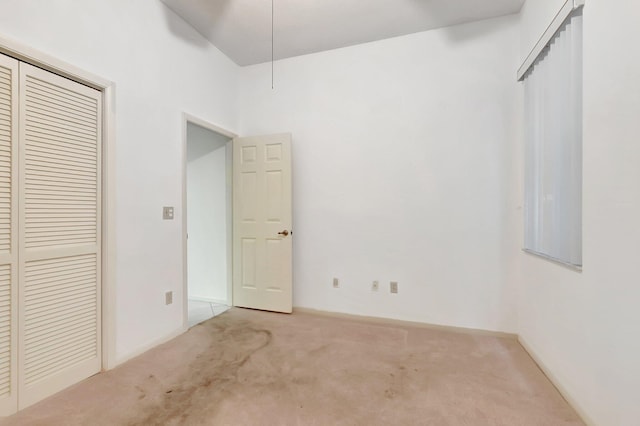 unfurnished bedroom featuring a closet and carpet flooring