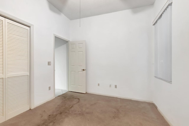 unfurnished bedroom with a closet and carpet flooring