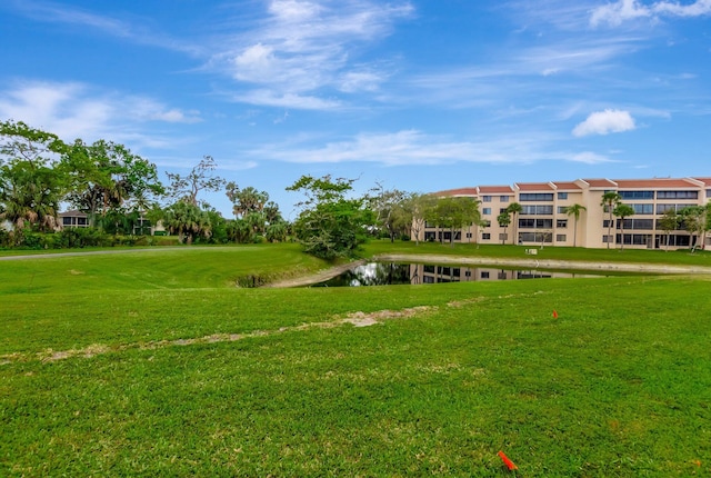 view of community with a water view and a lawn