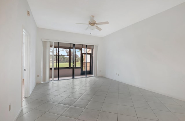 empty room with light tile patterned floors and a ceiling fan